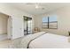 A comfortable main bedroom with a ceiling fan, ample lighting, and a view of the lanai at 24065 Canterwood Way, Venice, FL 34293