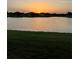 Sunset view of a pond with houses in the background at 24065 Canterwood Way, Venice, FL 34293