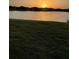 Sunset view of a pond in a residential community at 24065 Canterwood Way, Venice, FL 34293