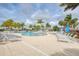 Resort-style pool with palm trees, lounge chairs, and blue umbrellas at 24065 Canterwood Way, Venice, FL 34293