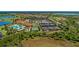 Aerial view of tennis courts, clubhouse, and pool in a luxury golf community at 24065 Canterwood Way, Venice, FL 34293