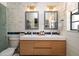 Elegant bathroom featuring double sinks, white cabinets, and modern fixtures at 2715 36Th Avenue E Ter, Bradenton, FL 34208
