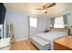 Comfortable bedroom with light walls, decorative wallpaper, hardwood floors, and natural light at 2715 36Th Avenue E Ter, Bradenton, FL 34208