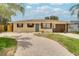 Inviting single-story home with a brick-paved driveway, well-kept lawn, and a tidy front garden at 2715 36Th Avenue E Ter, Bradenton, FL 34208