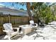 Cozy backyard seating area with Adirondack chairs, fire pit, and a grill for outdoor entertaining at 2908 Gulf Dr, Holmes Beach, FL 34217
