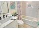 Well-lit bathroom with a white tiled shower, decorative shower curtain, and a clean, modern vanity at 2908 Gulf Dr, Holmes Beach, FL 34217