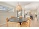Charming dining area with modern lighting, wooden table and chairs, and views into the kitchen at 2908 Gulf Dr, Holmes Beach, FL 34217