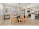 Bright dining room with modern lighting, wood table and chairs, and an open layout to the kitchen at 2908 Gulf Dr, Holmes Beach, FL 34217
