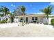 Charming single-story home with a minimalist landscaped front yard and a modern black front door at 2908 Gulf Dr, Holmes Beach, FL 34217