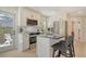 Bright, modern kitchen with stainless steel appliances, island with bar seating, and access to the backyard at 2908 Gulf Dr, Holmes Beach, FL 34217