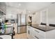 Modern kitchen features stainless steel refrigerator, white cabinets, and a dark countertop island at 2908 Gulf Dr, Holmes Beach, FL 34217
