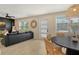 Open-concept living space with dining area featuring modern decor, ceiling fan and outdoor views at 2908 Gulf Dr, Holmes Beach, FL 34217
