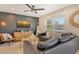 Inviting living room with dark accent wall, TV, comfortable seating, ceiling fan and natural light at 2908 Gulf Dr, Holmes Beach, FL 34217