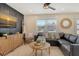 Comfortable living room featuring a large sectional, ceiling fan, decor and an accent wall at 2908 Gulf Dr, Holmes Beach, FL 34217