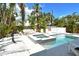 Private backyard oasis with pool, spa, dining area, lush landscaping, and ample seating at 2908 Gulf Dr, Holmes Beach, FL 34217