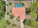 Aerial view of home with tile roof, pool, and landscaped yard at 321 Sorrento Dr, Osprey, FL 34229