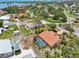 Aerial view showcases a home with a screened pool enclosure, palm trees and a terracotta roof at 321 Sorrento Dr, Osprey, FL 34229