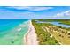 Stunning aerial shot showcasing the pristine shoreline and lush greenery along a beautiful, scenic coastline at 321 Sorrento Dr, Osprey, FL 34229