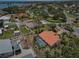 Aerial view of a home with a screened pool and backyard in a residential neighborhood at 321 Sorrento Dr, Osprey, FL 34229