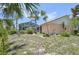 Wide backyard features mature trees, well-maintained plants, and large screened lanai at 321 Sorrento Dr, Osprey, FL 34229
