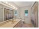 Bright bathroom features flamingo shower curtain and natural light from the window at 321 Sorrento Dr, Osprey, FL 34229