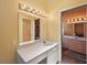 Bright bathroom boasts great vanity lighting and a big mirror at 321 Sorrento Dr, Osprey, FL 34229