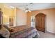 Cozy bedroom features a ceiling fan, skylight, and an adjacent bathroom for added convenience at 321 Sorrento Dr, Osprey, FL 34229