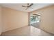 Bright bedroom features ceiling fan and sliding glass doors leading to the screened pool at 321 Sorrento Dr, Osprey, FL 34229