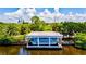 Charming boathouse with a boat, offering a picturesque waterfront scene surrounded by lush greenery at 321 Sorrento Dr, Osprey, FL 34229