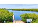 Picturesque boat ramp offering access to a tranquil waterway surrounded by lush green vegetation at 321 Sorrento Dr, Osprey, FL 34229