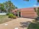 Home exterior with a tile roof, lush tropical landscaping, and a private driveway at 321 Sorrento Dr, Osprey, FL 34229