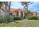Charming single-story home with arched entryway and lush tropical landscaping at 321 Sorrento Dr, Osprey, FL 34229