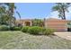 Charming single-story home with a well-manicured lawn and mature palm trees at 321 Sorrento Dr, Osprey, FL 34229