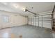 Clean empty garage with garage door and pedestrian door to the exterior at 321 Sorrento Dr, Osprey, FL 34229