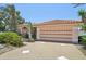 Spacious two-car garage with a decorative door and wide driveway at 321 Sorrento Dr, Osprey, FL 34229