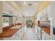 Bright kitchen with white cabinets, terra cotta countertops, and a breakfast nook area at 321 Sorrento Dr, Osprey, FL 34229