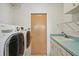 Laundry room with modern washer and dryer, and a utility sink at 321 Sorrento Dr, Osprey, FL 34229