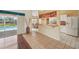 Inviting living room featuring tile floors, pool view, and an open layout to the kitchen at 321 Sorrento Dr, Osprey, FL 34229