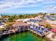 Vibrant outdoor restaurant featuring thatched roofs, blue umbrellas, and a scenic waterfront view at 321 Sorrento Dr, Osprey, FL 34229