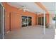 Covered patio with ceiling fans and sliding glass doors to the exterior at 321 Sorrento Dr, Osprey, FL 34229
