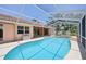 Beautiful kidney-shaped pool surrounded by lanai, offering a refreshing retreat with plenty of space at 321 Sorrento Dr, Osprey, FL 34229
