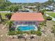 Aerial perspective highlights the screened pool with a terracotta-tiled roof at 321 Sorrento Dr, Osprey, FL 34229