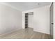 Empty bedroom features wood-look flooring, neutral paint, and a closet with shelving at 3212 Ramblewood N Dr # 3212, Sarasota, FL 34237