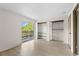 This bedroom features wood floors, balcony access, and closet organizer systems at 3212 Ramblewood N Dr # 3212, Sarasota, FL 34237