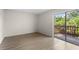 Bright bedroom with wood-look flooring and sliding glass doors to a balcony at 3212 Ramblewood N Dr # 3212, Sarasota, FL 34237