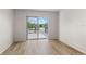 Bedroom featuring wood-look floors, access to a private patio with a metal railing, and lots of light at 3212 Ramblewood N Dr # 3212, Sarasota, FL 34237