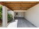 Covered carport area for multiple cars, featuring neutral paint, wood accents, and lush landscaping at 3212 Ramblewood N Dr # 3212, Sarasota, FL 34237