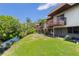 Home exterior featuring multiple balconies, well-maintained landscaping, and water access at 3212 Ramblewood N Dr # 3212, Sarasota, FL 34237