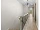 Hallway with wood-look flooring, decorative light fixture, and access to a balcony at 3212 Ramblewood N Dr # 3212, Sarasota, FL 34237