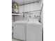 Laundry room featuring a washer and dryer hookup, storage shelves, and utility access at 3212 Ramblewood N Dr # 3212, Sarasota, FL 34237